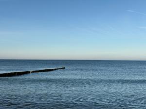 a pier in the middle of a large body of water at Fiskerhytte - Meine Fischerhütte in Börgerende-Rethwisch