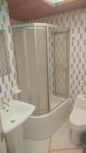 a bathroom with a tub and a sink and a toilet at Colibri Hostel in Armenia