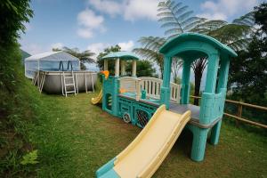 a playground with a train and a slide at ZOYA HILLS in Pondok Cipaseban