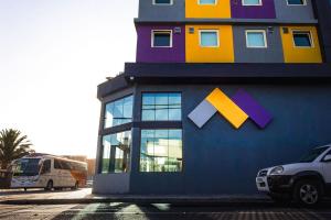 a colorful building with a large window on it at Hotel Modular Express Calama in Calama +25 photos