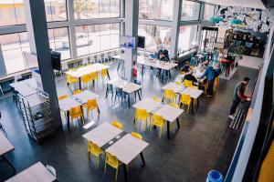 an overhead view of a restaurant with tables and yellow chairs at Hotel Modular Express Calama in Calama