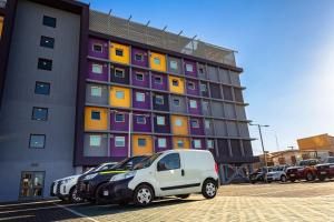 a white van parked in front of a building at Hotel Modular Express Calama in Calama
