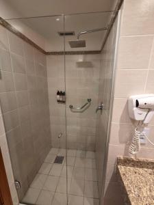 a shower with a glass door in a bathroom at Flat 1015 - Comfort Hotel Taguatinga in Brasilia