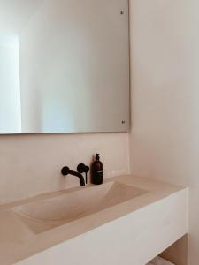 a bathroom sink with a soap dispenser on it at Together Boutique Villa in Ahangama +47 photos