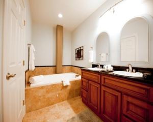 a bathroom with two sinks and a bath tub at The Valley in Vicksburg +37 photos