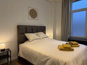 En eller flere senge i et værelse på Suite Luxueuse avec jaccuzi sans vis-à-vis