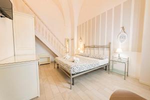 a bedroom with a bed and a staircase at InCentro b&b in Porto Cesareo