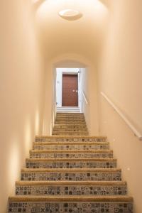 a set of stairs with a door in the background at Casa Tanina in Bitonto