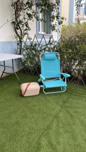 a chair sitting on the grass next to a table at Casa Praia Verde V3 in Castro Marim