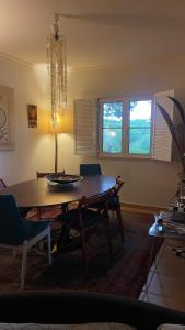 a dining room table and chairs in a living room at Casa Praia Verde V3 in Castro Marim
