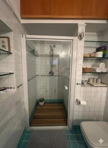 a shower with a glass door in a bathroom at Casa di Lorena - Dream view in Maiori +13 photos
