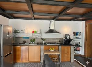 a kitchen with wooden cabinets and stainless steel appliances at Casa di Lorena - Dream view in Maiori
