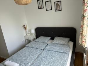 a bedroom with a bed and two pillows on it at Bazsarózsa Kuckó in Pécsvárad