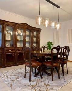 a dining room with a wooden table and chairs at Casa Vista para a Serra in Casais do Livramento
