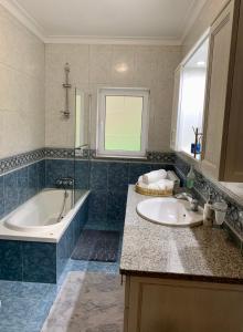 a bathroom with a tub and a sink and a bath tub at Casa Vista para a Serra in Casais do Livramento +18 photos