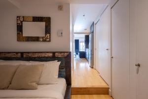 a bedroom with a bed next to a hallway at Les Immeubles Charlevoix - Le 1168 in Quebec City +6 photos