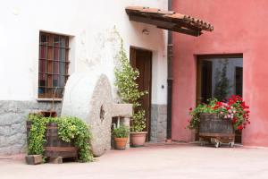 a building with potted plants in front of a building at B&B La Ceramica Moline in Vicoforte