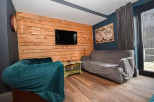 a living room with a couch and a flat screen tv at 3 Private Rooms in Shared Apartment with Kitchen in Leeds +7 photos