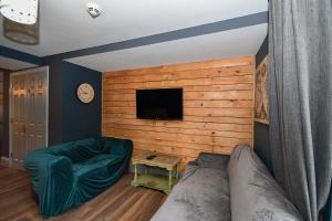 a living room with a couch and a flat screen tv at 3 Private Rooms in Shared Apartment with Kitchen in Leeds