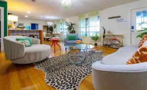 a living room with two chairs and a table at Jungle Haven Heated Pool Fun for 12 in Johnson City
