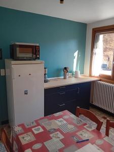een keuken met een tafel, een koelkast en een magnetron bij appartement thones in Thônes +10 foto's