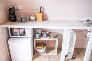 a small kitchen with a table and a sink at L'Escapade dans les Prés in Les Pégués