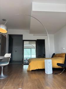a bedroom with a bed and a desk and a chair at Design studio met hotel vibe in Antwerp