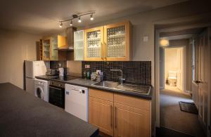 een keuken met een wastafel en een vaatwasser bij Dunvegan Castle Laundry Cottage in Dunvegan +9 foto's