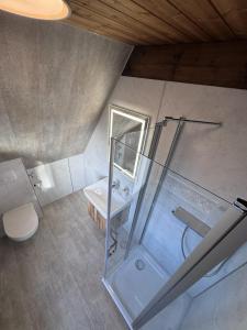 an overhead view of a bathroom with a shower and a sink at Twiste Retreat 126 in Bad Arolsen