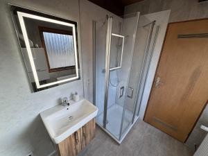 a bathroom with a sink and a shower at Twiste Retreat 126 in Bad Arolsen +8 photos
