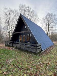 a small house with a solar roof on a field at Twiste Retreat 126 in Bad Arolsen