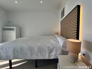 a bedroom with a bed and a table with a lamp at Los Roquitos II in El Paso +11 photos