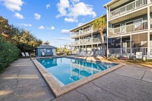 a swimming pool in front of a building at Grandy 30A in Inlet Beach