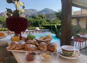 a tray of bread and pastries on a table at B&B Sole in Trappitello