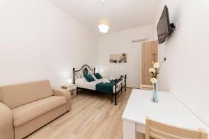 a living room with a couch and a bed at LORY'S HOUSE in Porto Cesareo +18 photos
