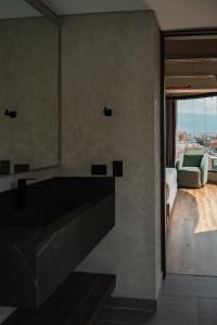 a bathroom with a large bath tub and a couch at Uukam by Bernalo Hotels in Medellín
