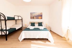a bedroom with two bunk beds in a room at LORY'S HOUSE in Porto Cesareo