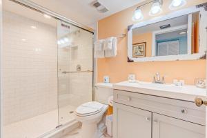 a bathroom with a toilet and a shower and a sink at Van Lee 1003 - Oceanview Beach Condo in Ormond Beach +17 photos
