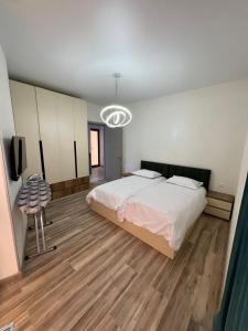 a bedroom with a bed and a television in it at Marhaba Villa in Borjomi