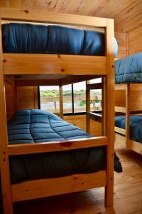 two bunk beds in a room with a window at Cabañas Isla del Mar in Constitución