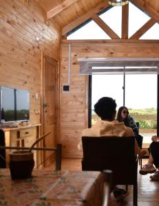 a group of people sitting in a room with a television at Cabañas Isla del Mar in Constitución