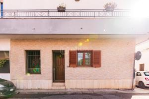 a building with a door and a balcony at Maridea Flat in Porto Cesareo