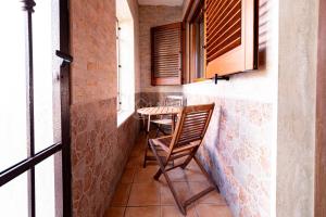 a small balcony with two chairs and a table at Maridea Flat in Porto Cesareo