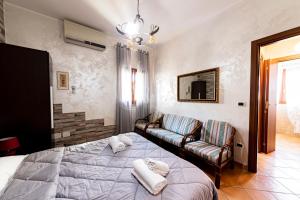 a living room with a bed and a couch at Maridea Flat in Porto Cesareo