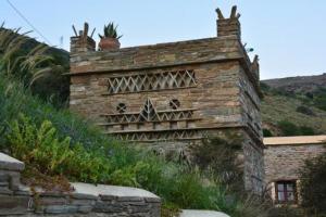 an old brick building with plants on the side of it at Anastasia Luxury Villas in Gavrio