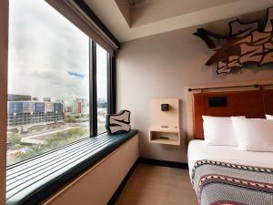a room with a window with a bed and a view at Moxy Miami Wynwood in Miami