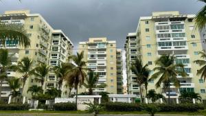a group of tall buildings with palm trees in front at Malecón view mar apartment in Colorado