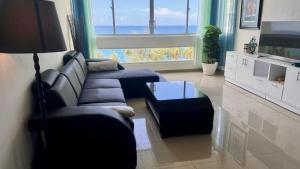 a living room with a couch and a table at Malecón view mar apartment in Colorado