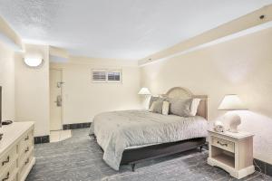 a white bedroom with a bed and a dresser and a bed sidx sidx sidx at Daytona Beach Resort 532-White Turtle in Daytona Beach +27 photos