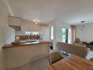 a kitchen and living room with a table and a counter at Guest house Noemi in Marčana